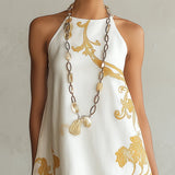 Hersilia | Vestido mini de encaje blanco con motivos dorados
